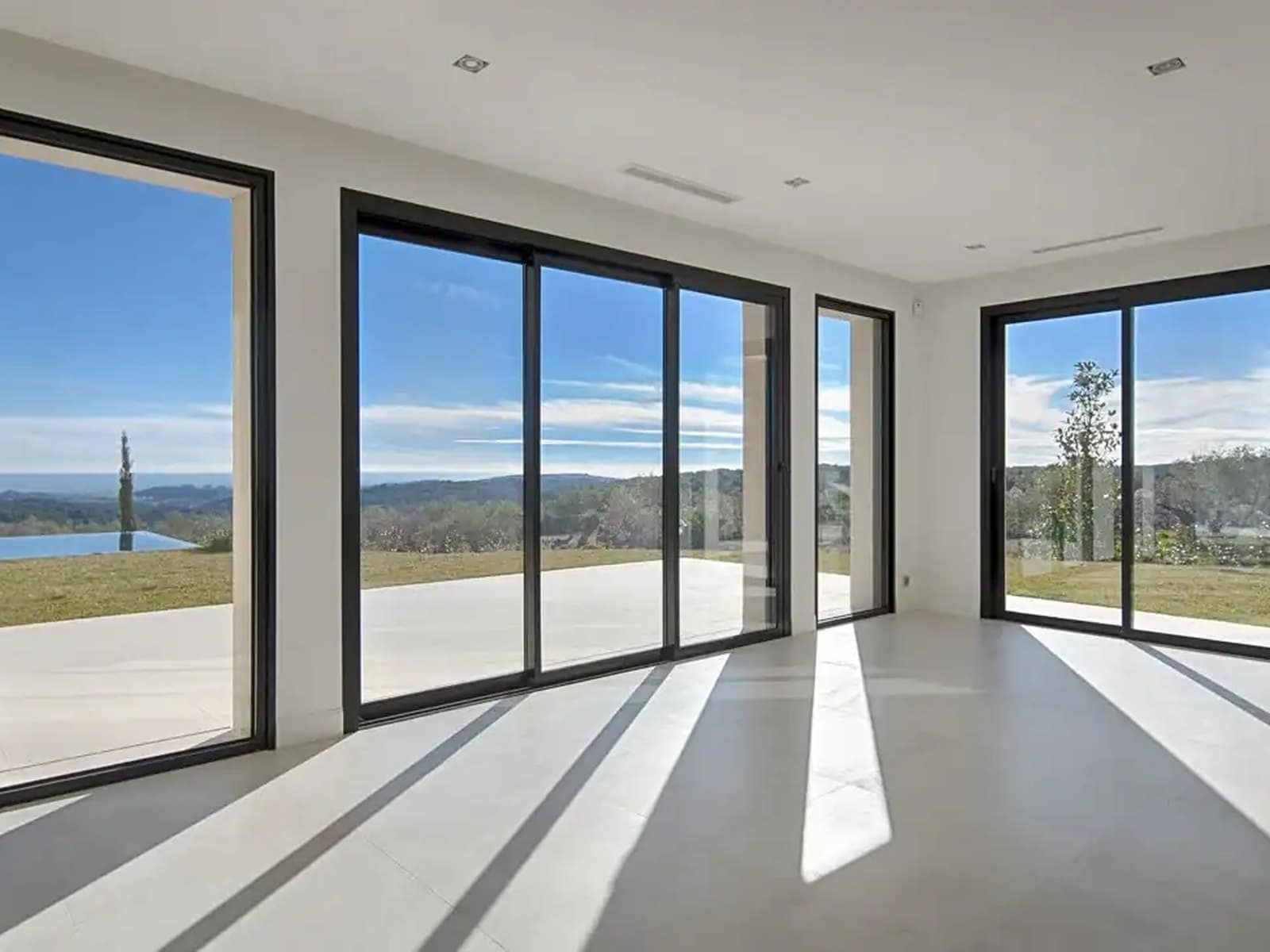 A wide multi-panel Cortizo slider framing an open landscape