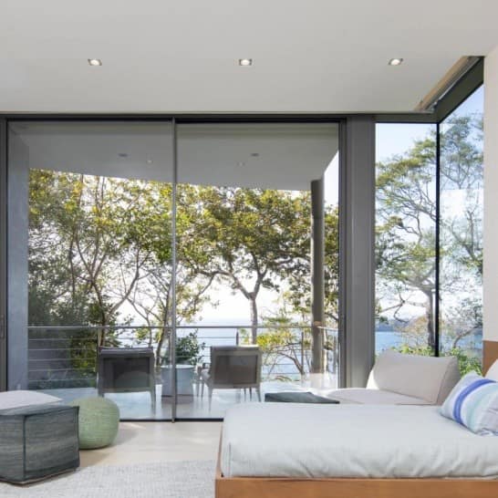 Slim-frame glass doors open to a Lake Conroe waterfront home