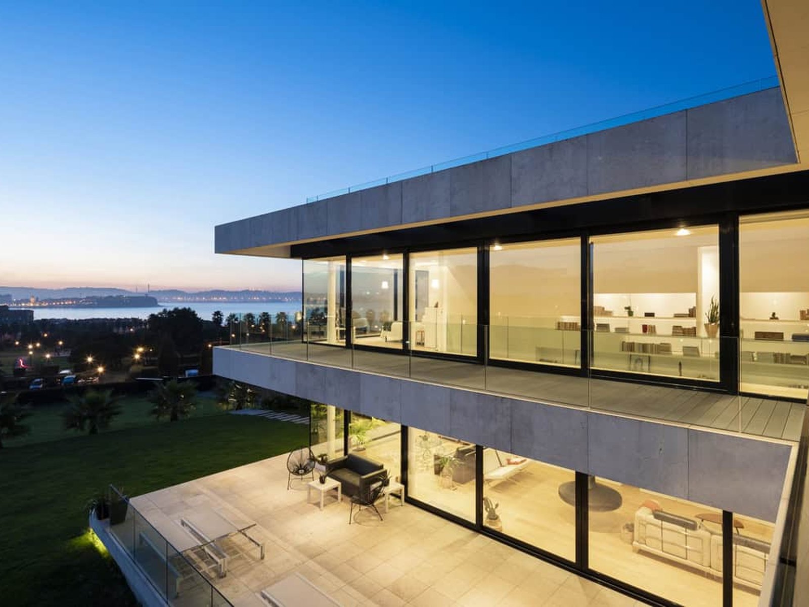 A wide aluminum sliding door with narrow sightlines opening onto a terrace